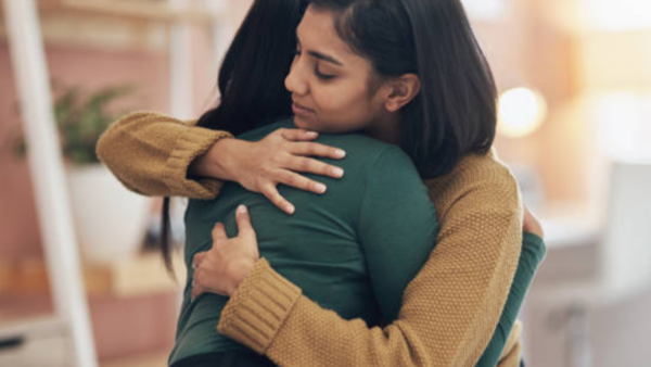 two women hugging for comfort